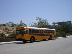 Rear Engine School Bus Stopped at a Curb