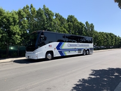 Motor Coach parked at a school waiting for passengers